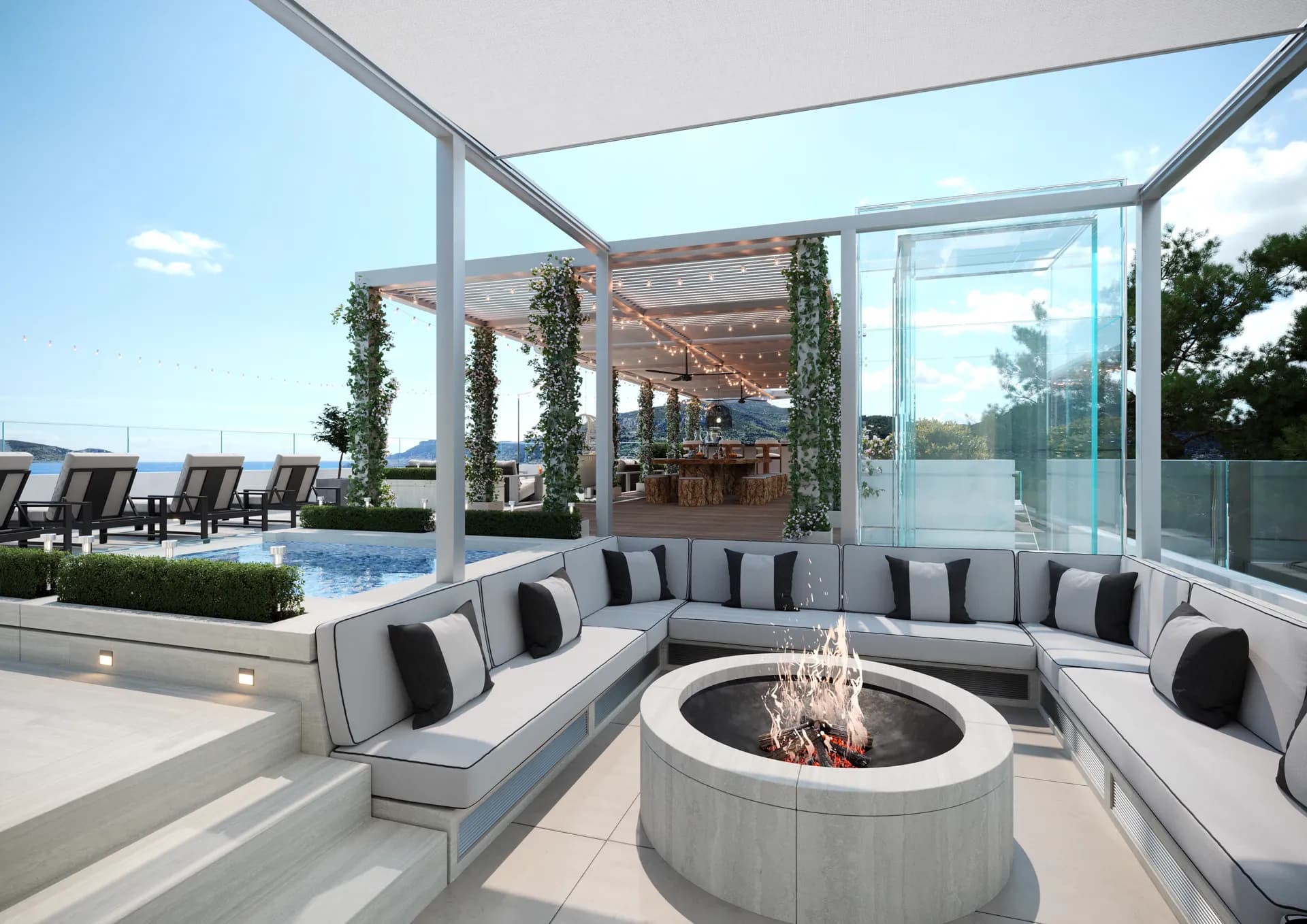 Sunken outdoor lounge around a fire pit under a glass pergola — Villa Luna, Cap Martin
