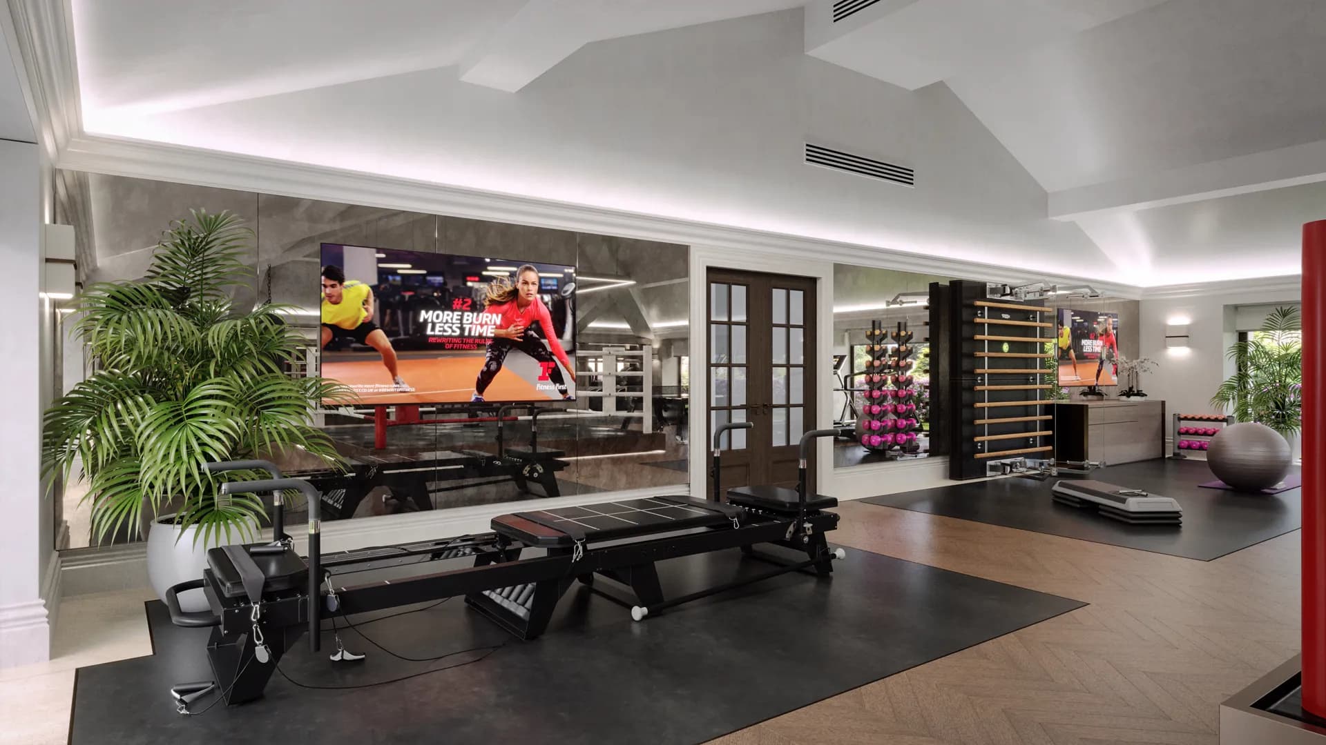 Home gym with Pilates reformers, a wall bar and a large screen — Windsor Estate, Windsor